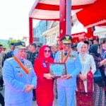 Gubernur Sulawesi Tengah Dr. H. Anwar Hafid, M.Si. menyerahkan penghargaan kepada Direktur Utama Bank Sulteng Hj. Ramiyatie.